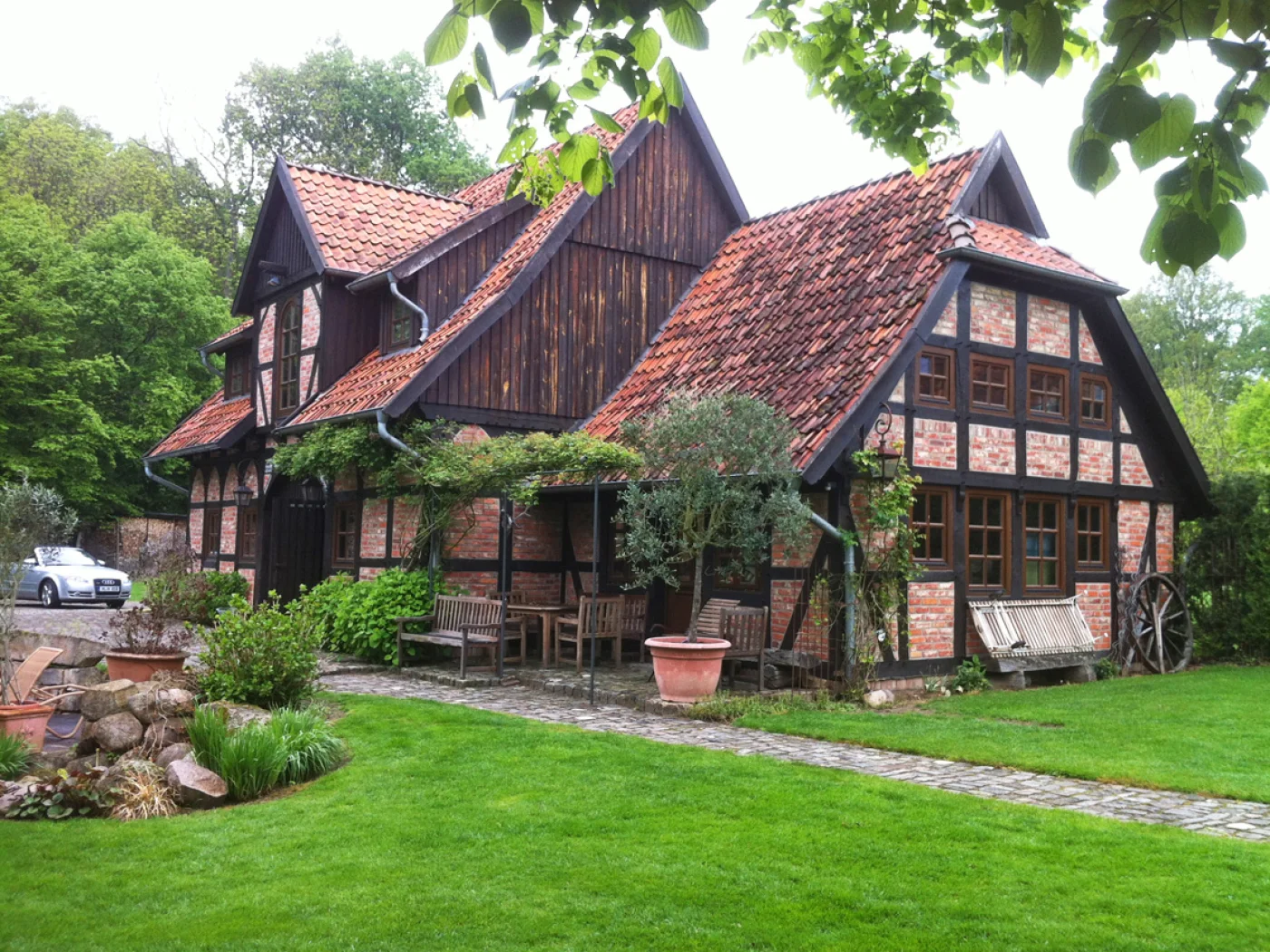 Ein großes Fachwerknebengebäude mit historischer Eiche